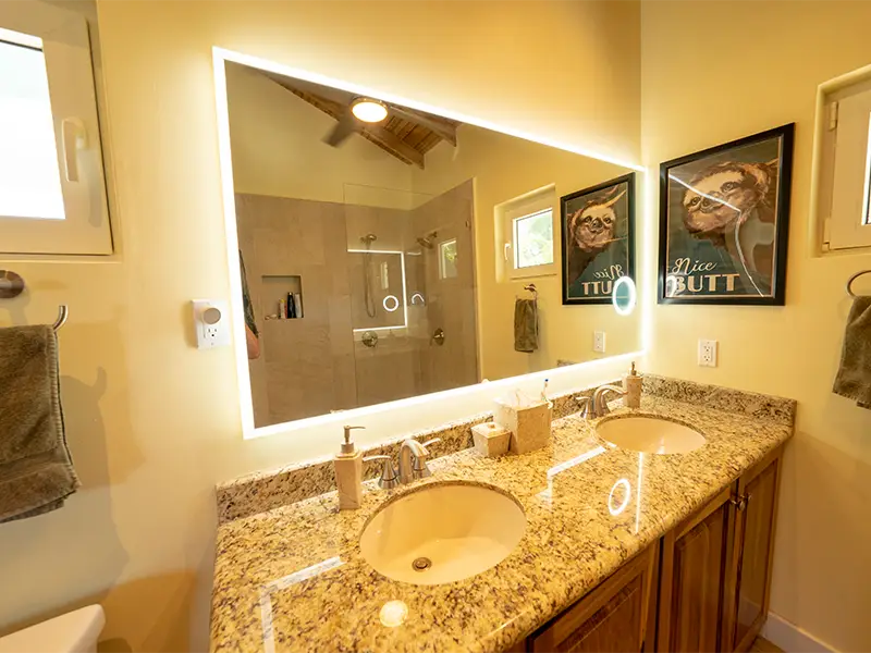 Dual-Sink Vanity In Bathroom with LED Mirror.