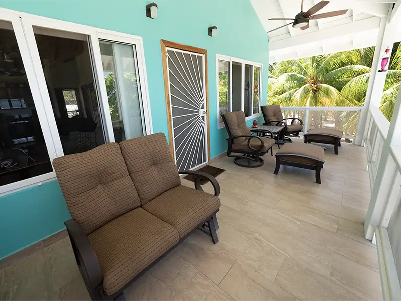 Ocean Front Porch with Chairs, Swing & Table.