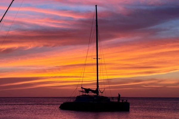 Why Visit Roatan - A Roatan sunset from a Catamaran in Sandy Bay, Roatan