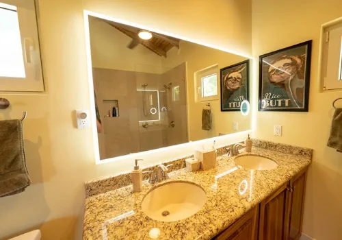 Dual-Sink Vanity In Bathroom with LED Mirror.
