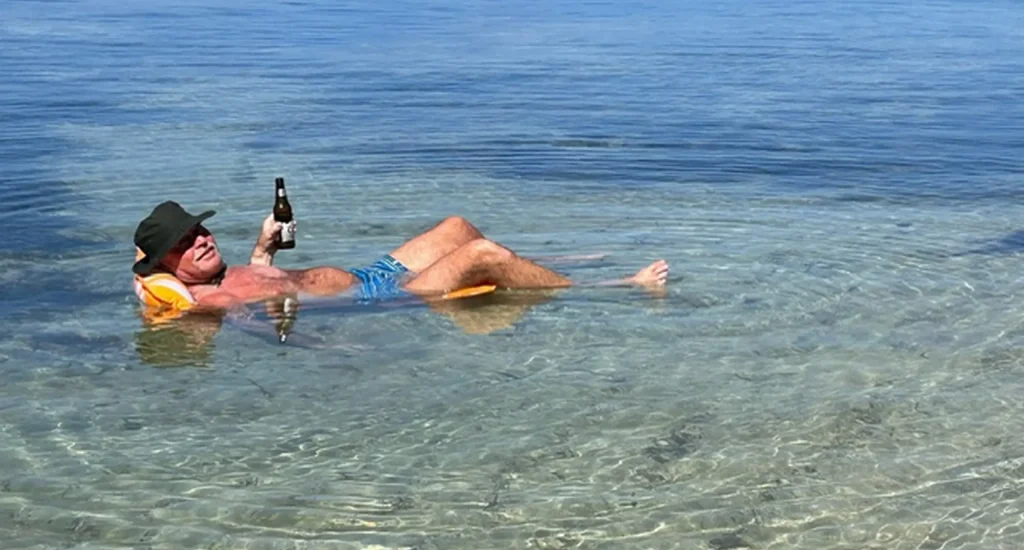 Guest relaxing on a floaty, in the ocean, at Hummingbird Casitas in Roatan